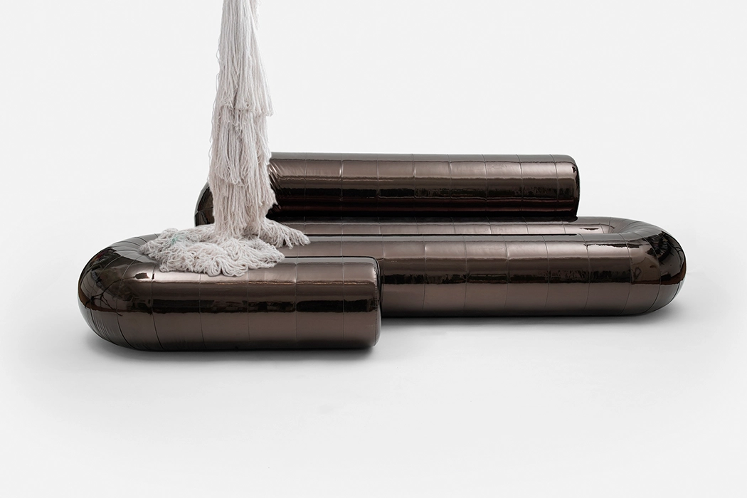 Serpentine sofa by Christophe de la Fontaine in dark copper